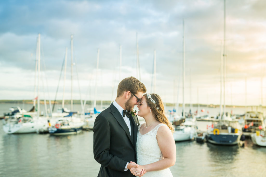 Wedding couple standing in front of the Charlottetown harbour.